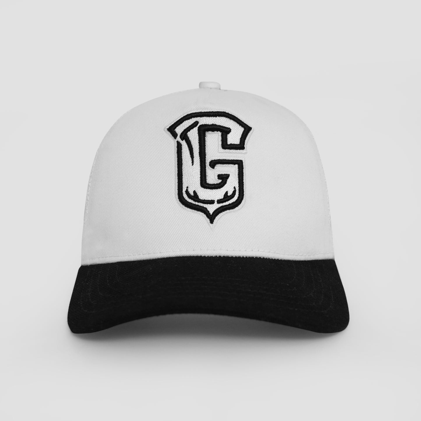 White and black cap with a large 'G' logo on a light gray background