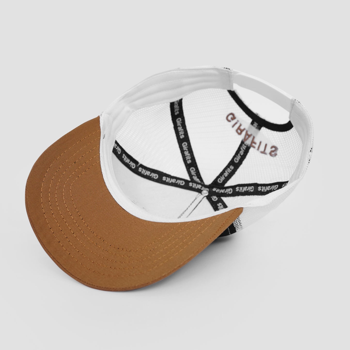 Cap with brown visor and white front panel on a light gray background