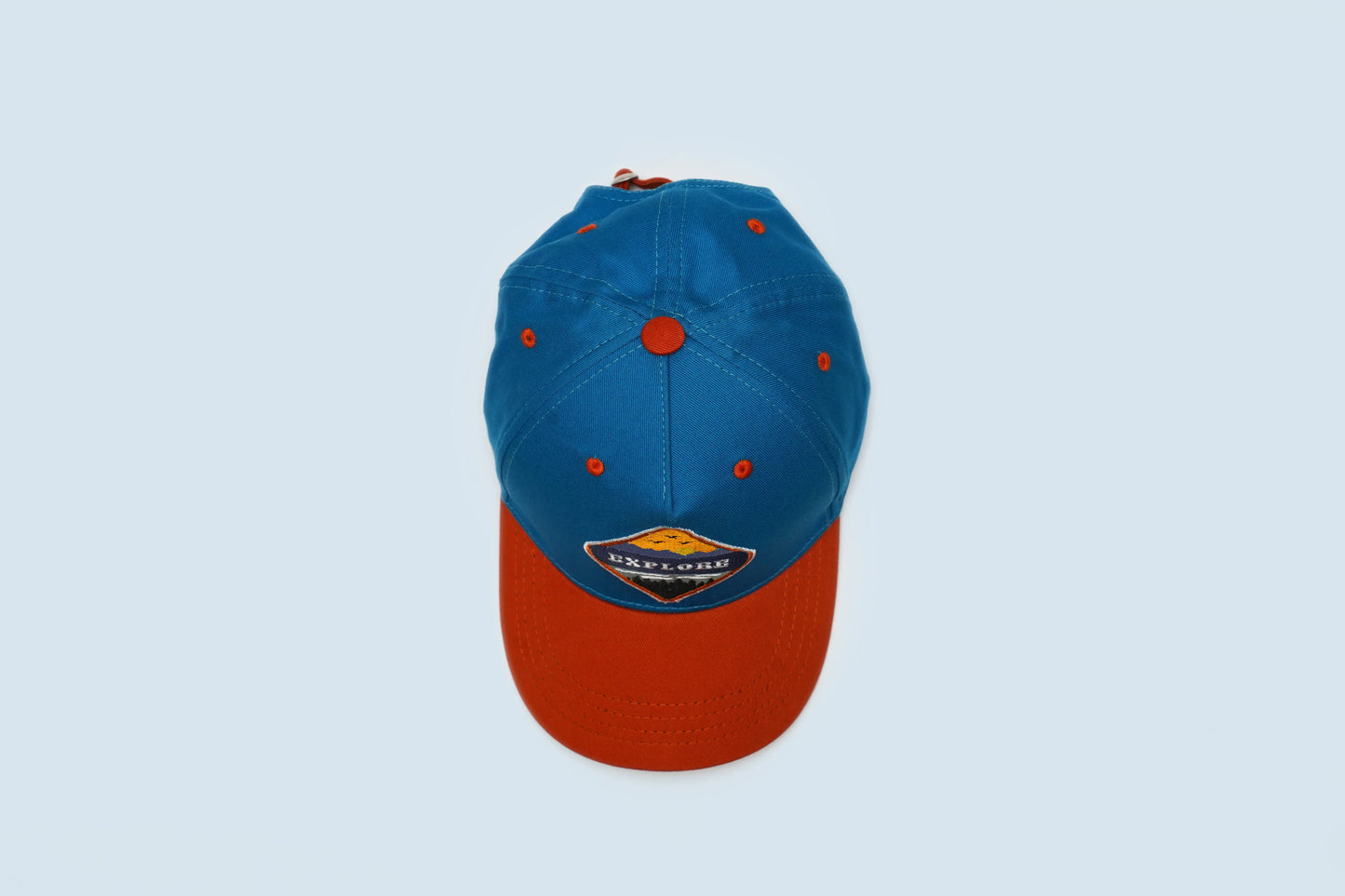 Dark blue and orange baseball cap with Explorer patch, packed in premium box