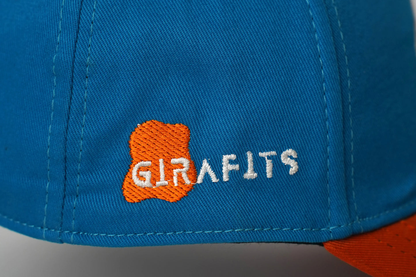 Dark blue and orange baseball cap with Girafits embroidery