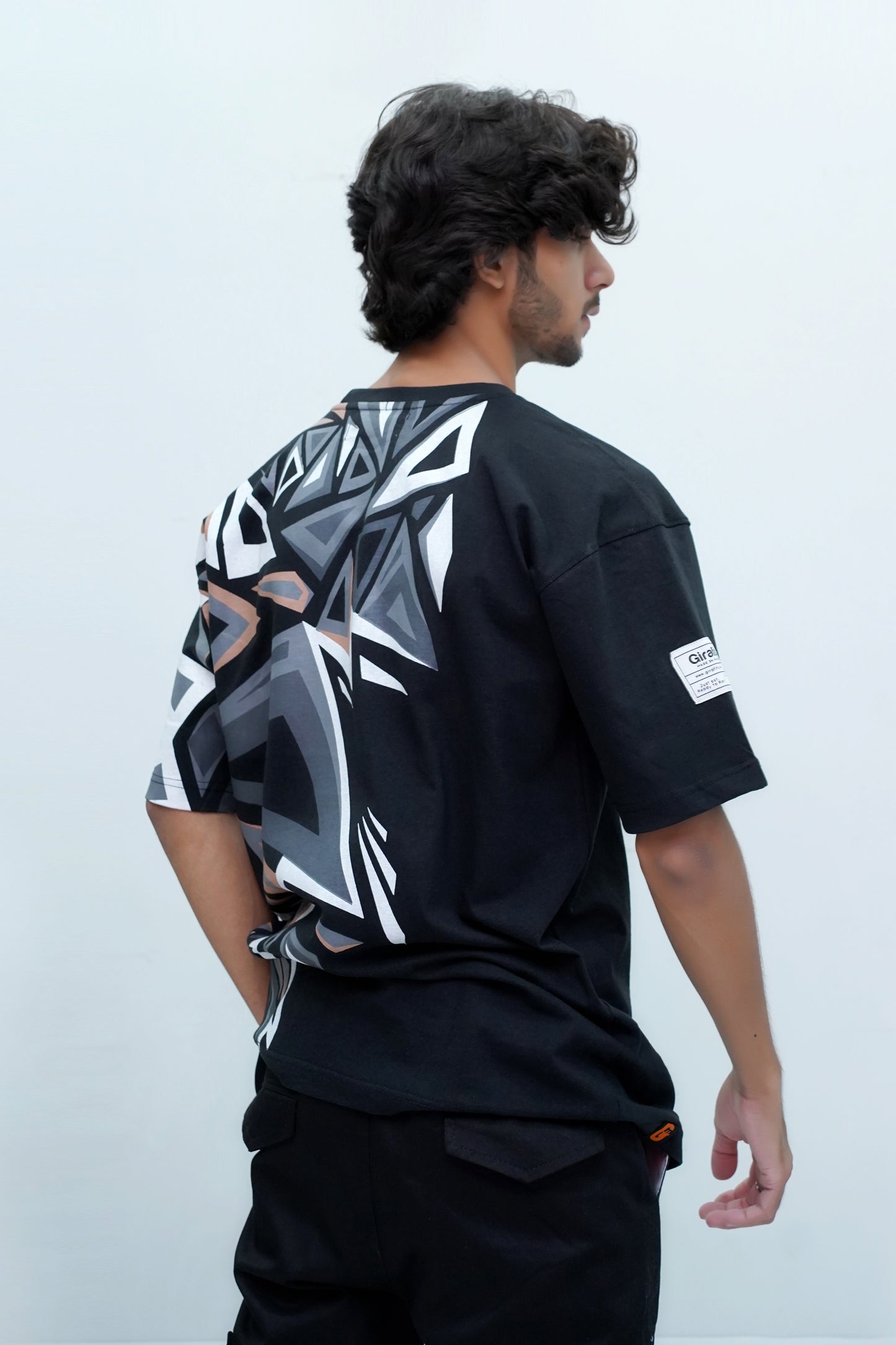 Black oversized t-shirt, streetwear style, abstract shape on front and back