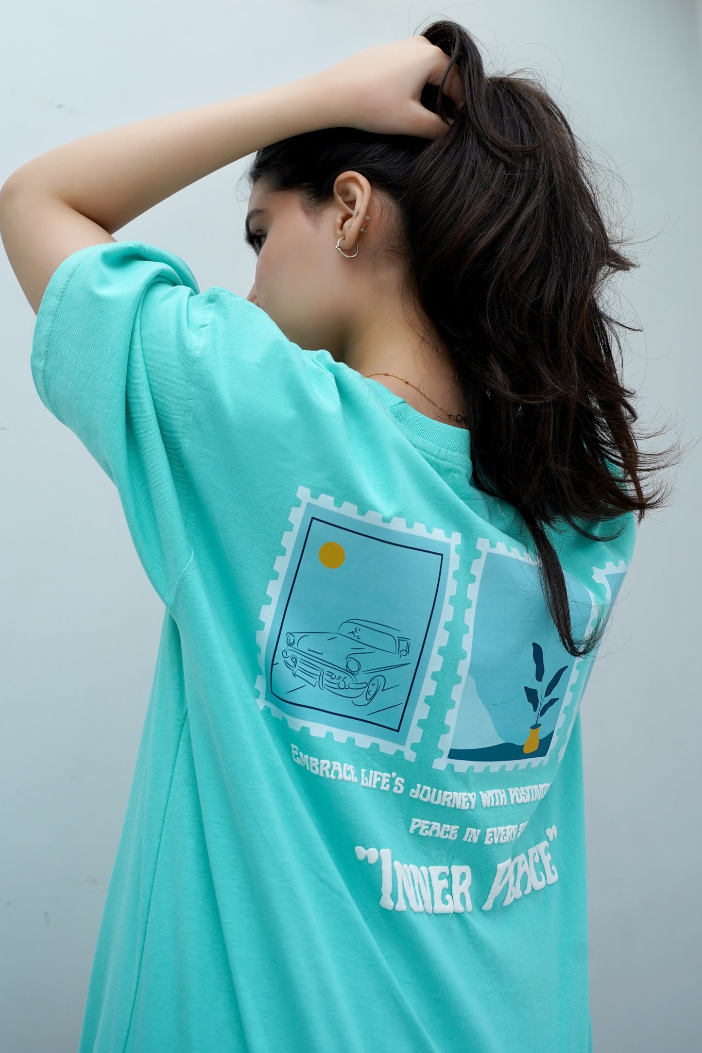 White T-shirt with puff print text and peaceful design elements