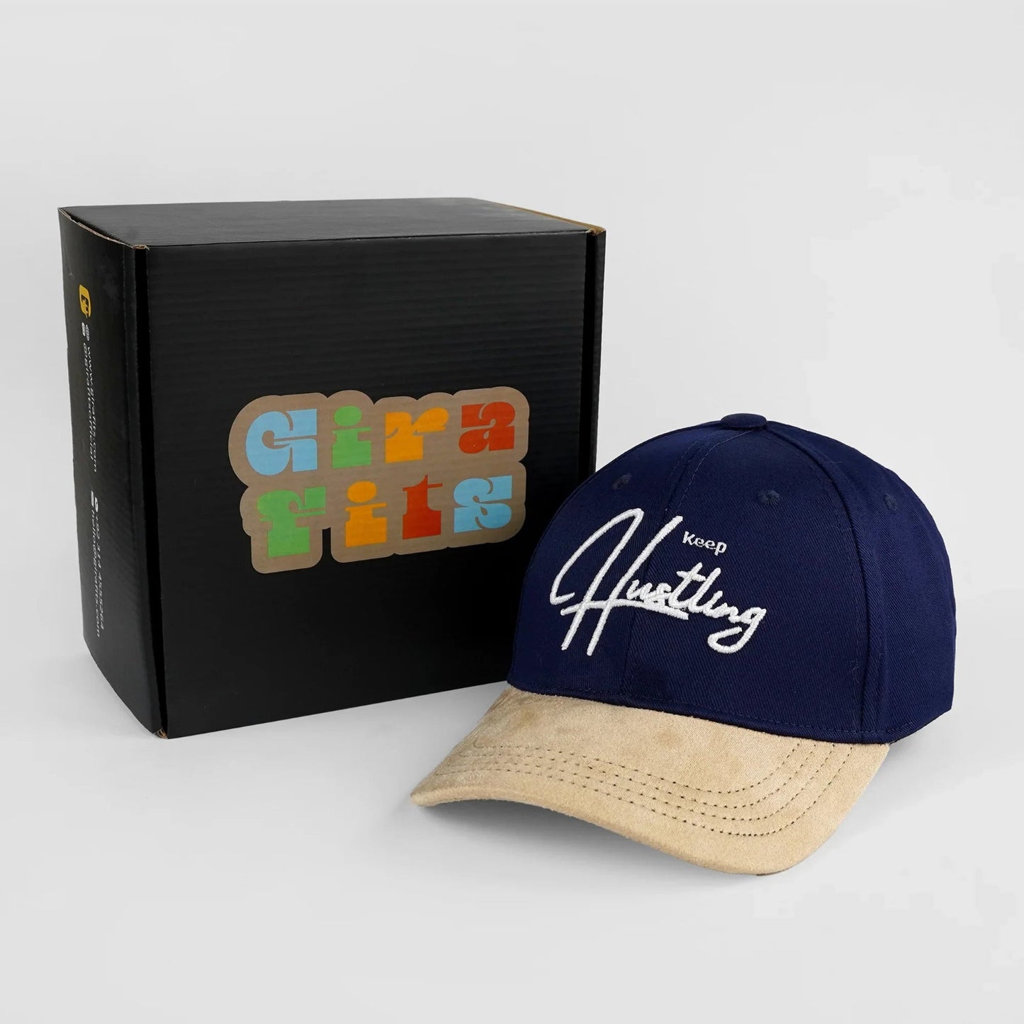 Indigo and camel baseball cap with 3D embroidered "Keep Hustling" text