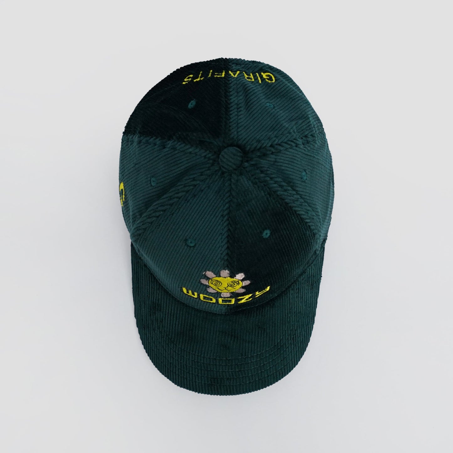 Green cap with yellow text and logo on a light gray background