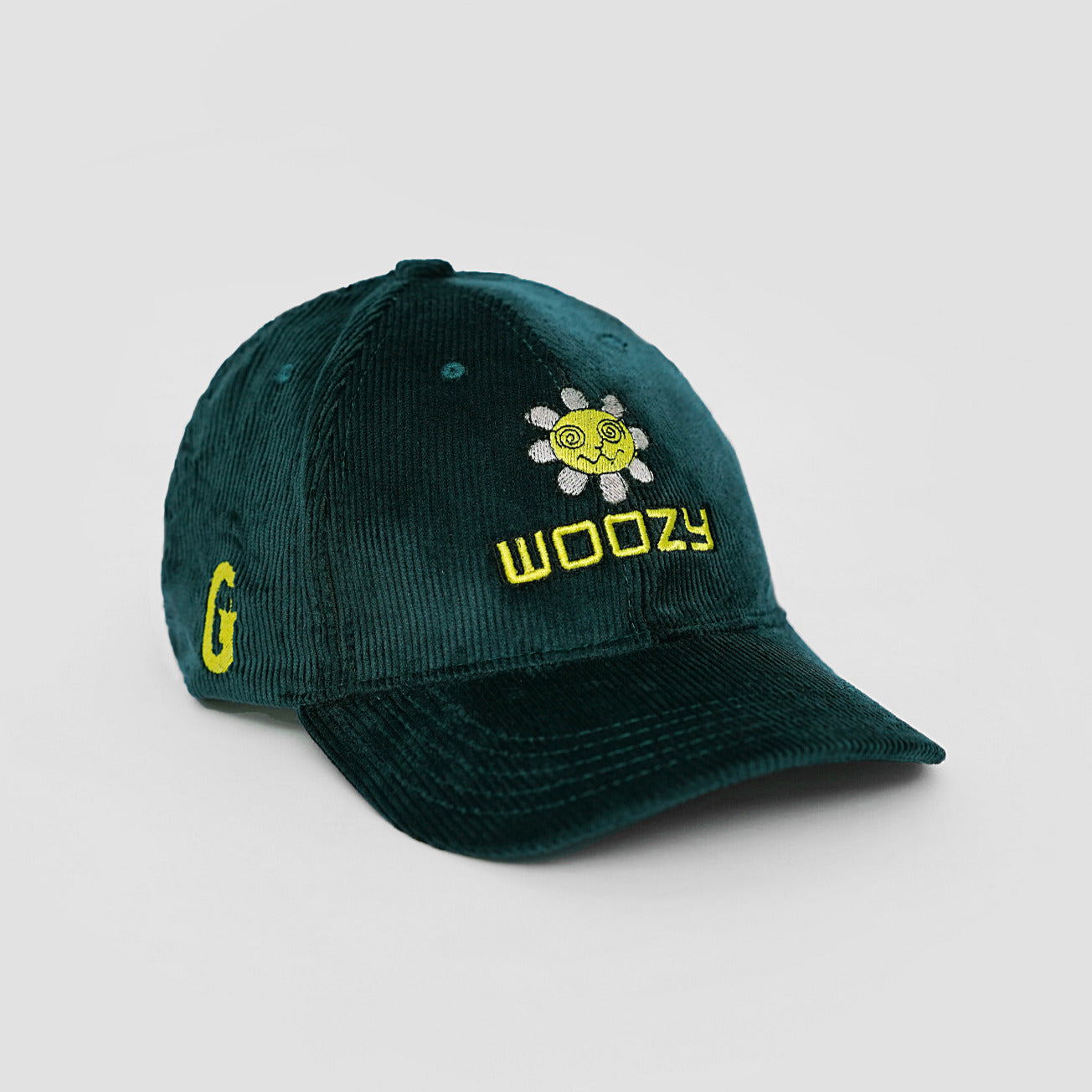 Green cap with yellow text and logo on a light gray background