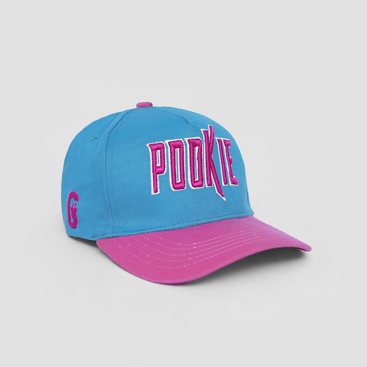 Blue and pink cap with 'POOKIE' text on a light gray background