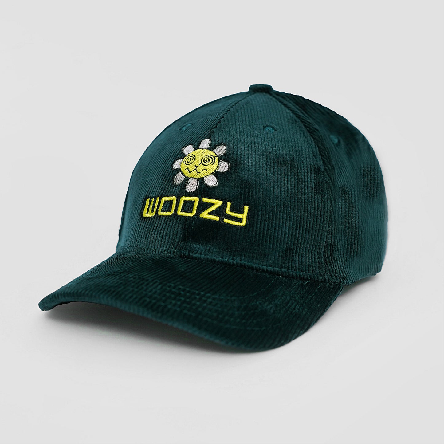 Green cap with 'Woozy' logo and sun design on a light gray background