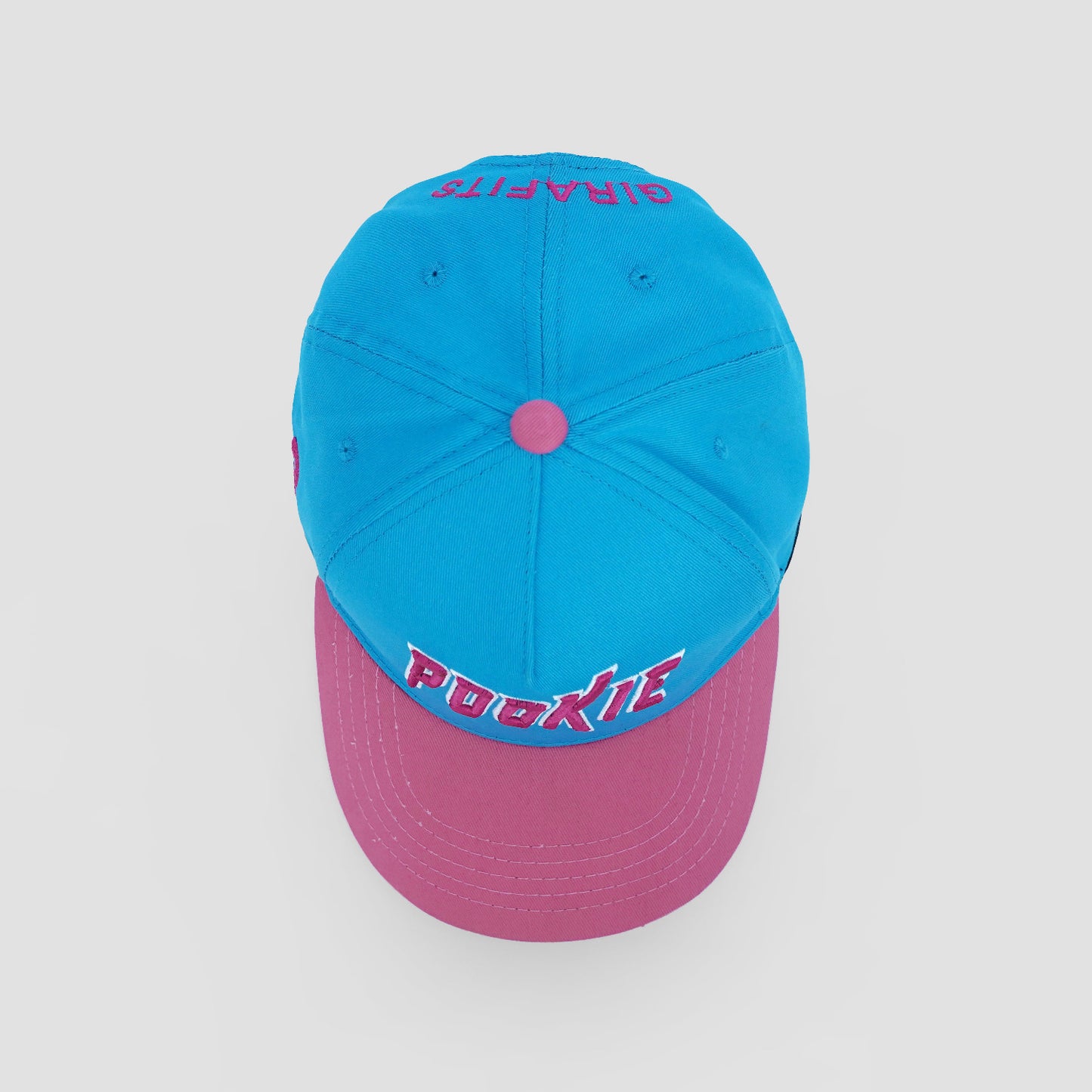 Two-tone blue and pink cap with text on a light gray background