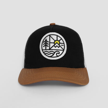 Black and brown cap with a circular emblem featuring trees, a sun, and water on a light gray background.