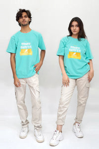 Two people wearing matching turquoise t-shirts with a logo on a white background
