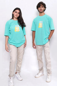 Two people wearing matching teal t-shirts with yellow text on a white background