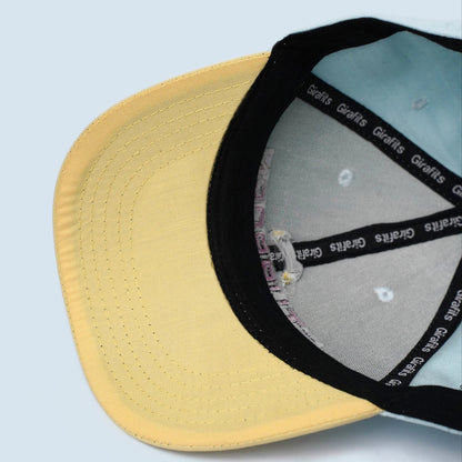 Sky blue and light yellow baseball cap with "Stubborn" text embroidery