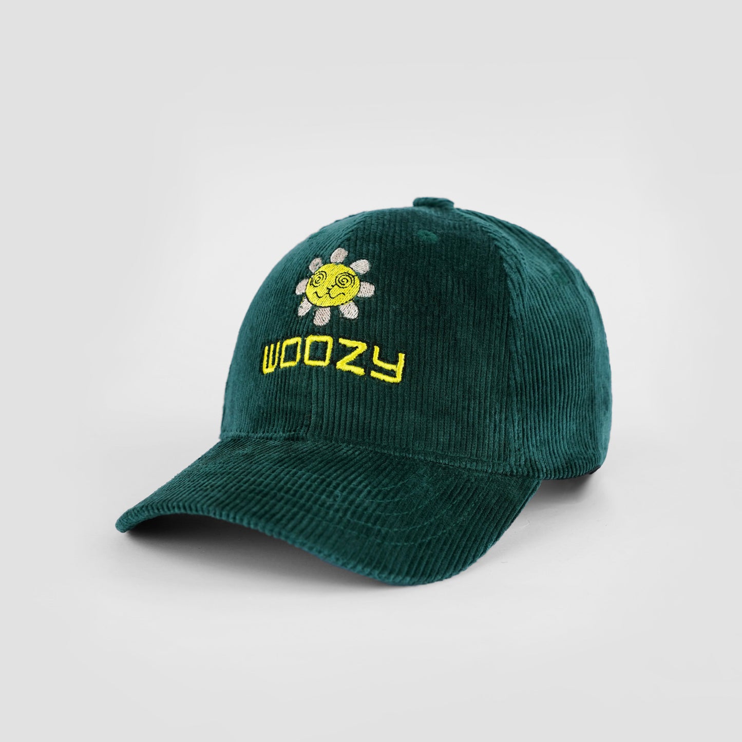 Green cap with 'Woozy' logo and sun design on a light gray background