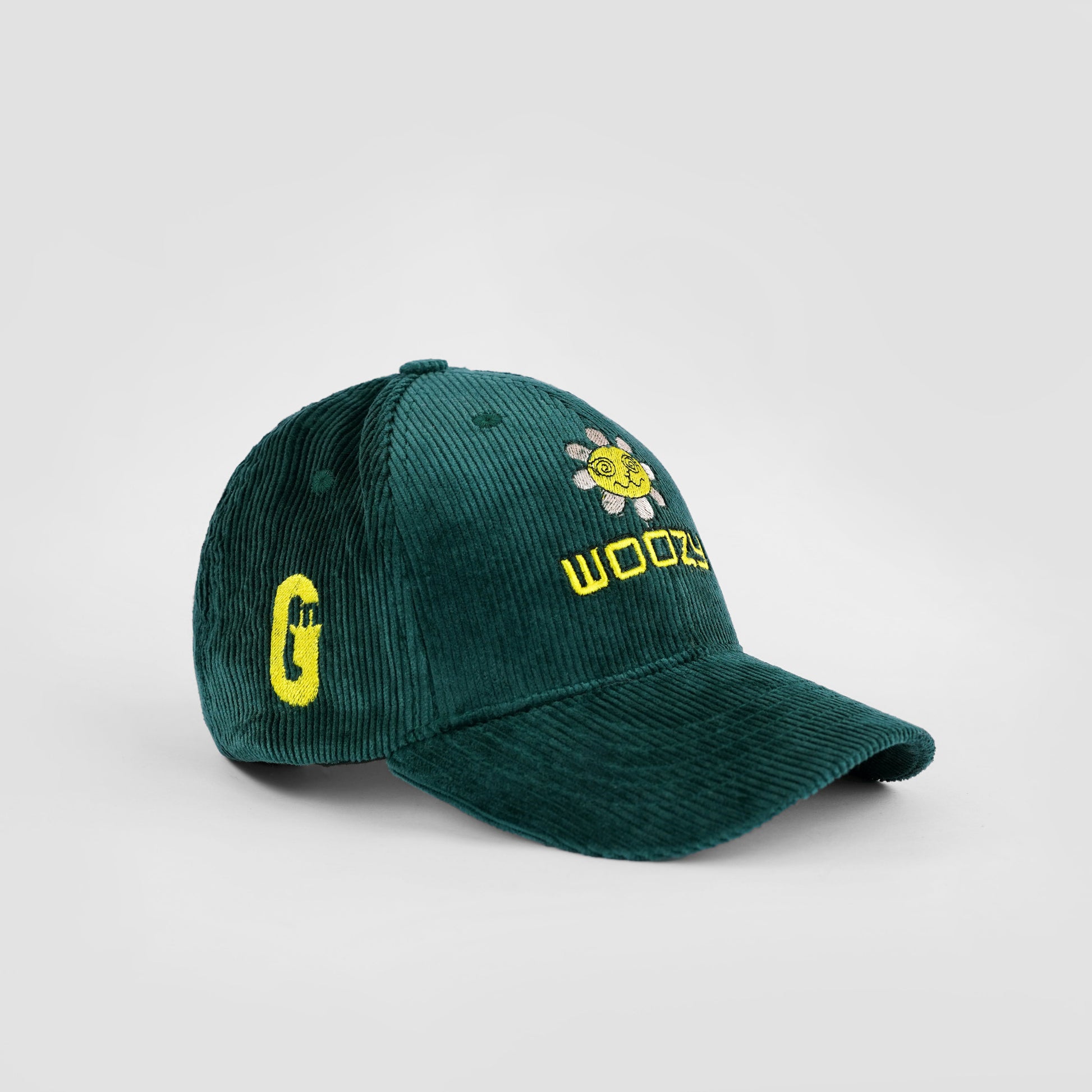 Green cap with yellow text and logo on a light gray background