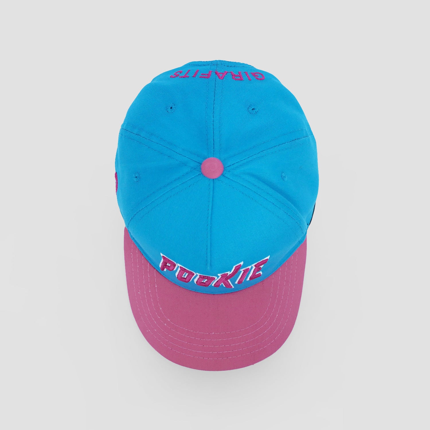 Two-tone blue and pink cap with text on a light gray background
