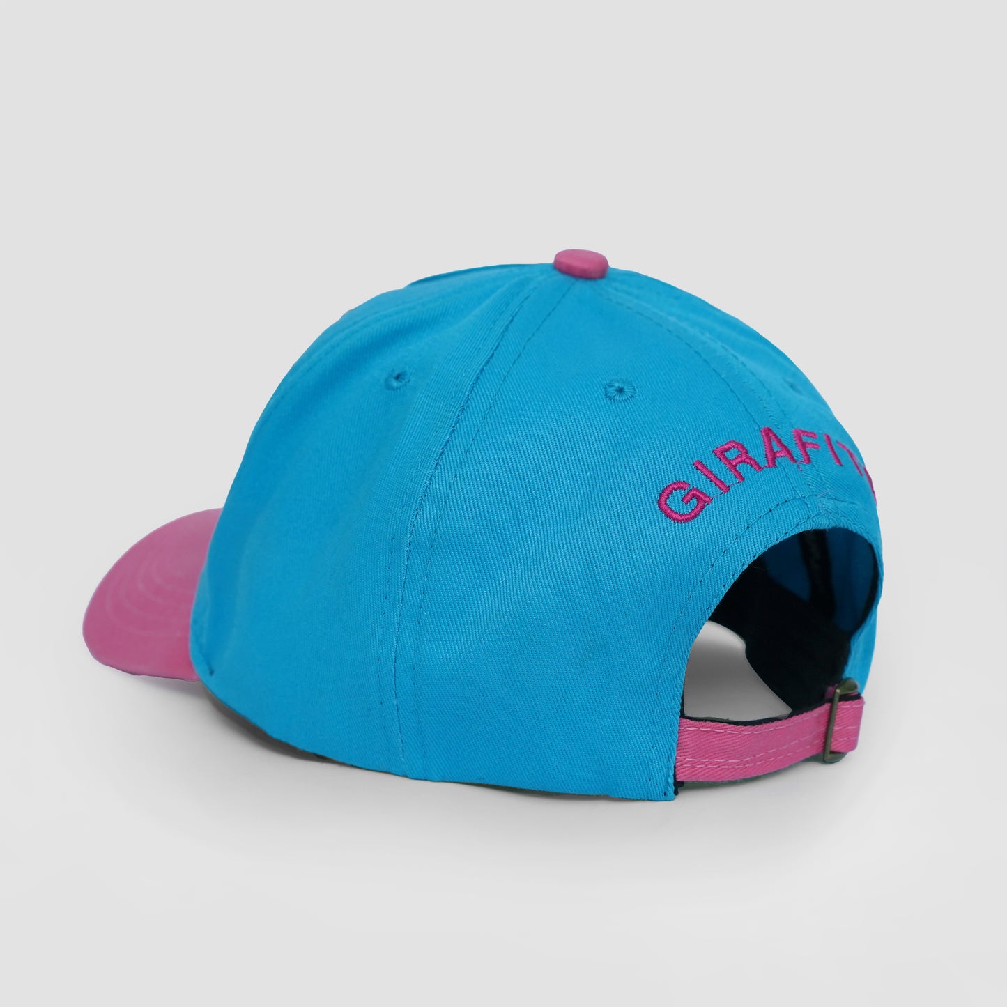 Blue and pink cap with 'Giraffe' branding on a light gray background