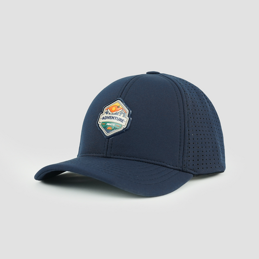 Navy softshell baseball cap with "Adventure Awaits" text and laser-cut vents