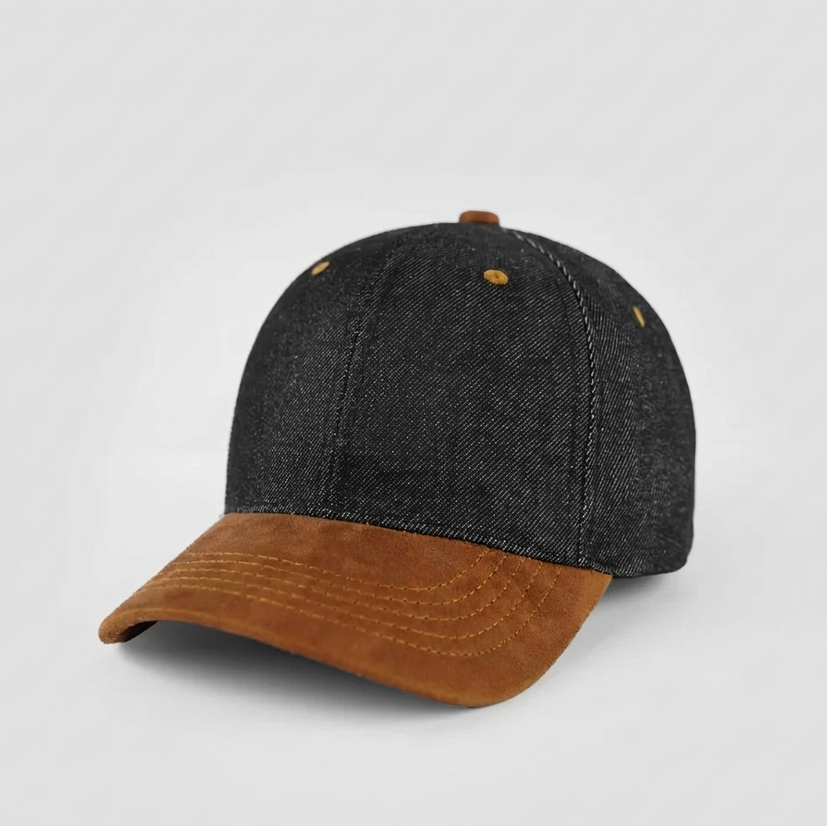 Black denim cap with brown brim on a light gray background