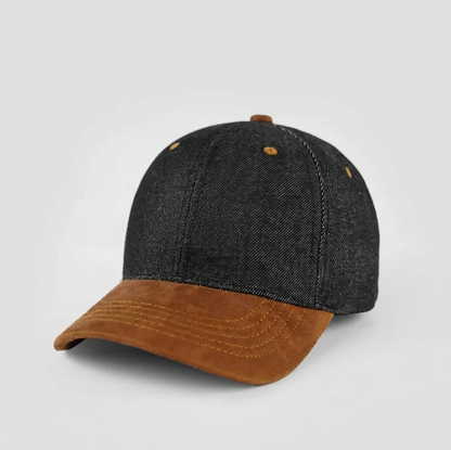 Black denim cap with brown brim on a light gray background