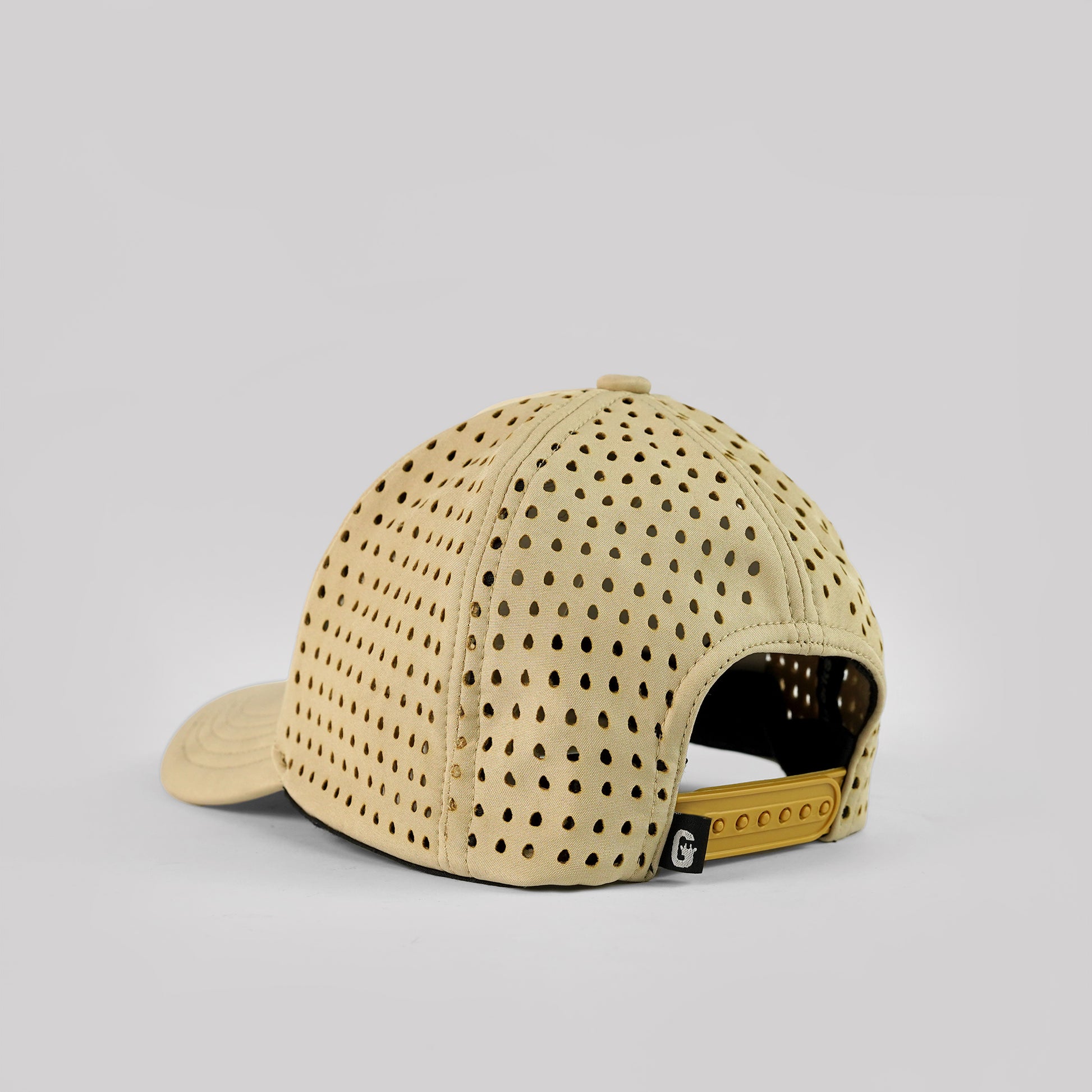 Beige cap with perforated design on a light gray background